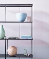 Black shelf unit with ceramics in pastel colours 