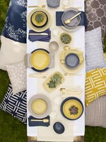 Overhead view of outdoor dining table with blue and yellow accessories 