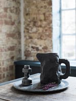 Rustic black jug on dining table 