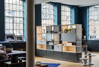 Shelving unit used as divider in industrial open plan living space
