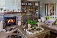 Lit fire in modern country living room 