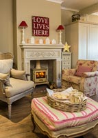 Lit wood burning stove in modern country living room 
