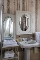 Country bathroom sink with stripped wooden walls 