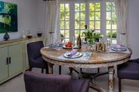Country dining room with purple chairs 