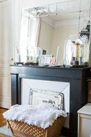Basket and vintage mirror around fireplace 