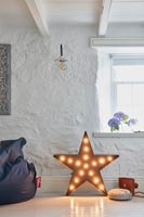 Star shaped light on floor of country living room 