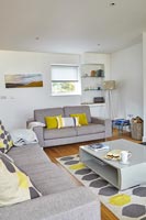 Modern living room with yellow and grey accessories 