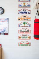 Racing car signs displayed on wall next to punch bag 