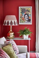 Colourful painting on red wall of modern living room 