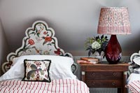 Decorative floral headboard in country bedroom 