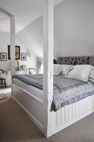White four poster bed in country bedroom 
