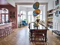 Kitchen-diner with pink painted kitchen and parquet floors 