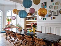 Modern dining room with collection of paper lantern lights over table 