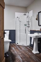 Black and white bathroom with stripped wooden flooring 