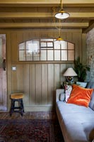 Brown painted wood panelling in country living room 