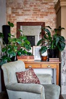 Armchair in country living room with exposed brick wall 