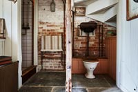 Wooden post and room divider in country bathroom 