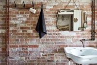 Exposed brick wall in bathroom 