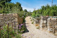 View of walled country garden path 