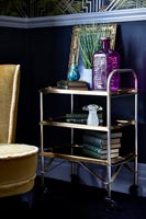 Gold vintage trolley as side table in eclectic living room 
