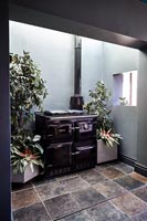 Large aga in alcove of black modern kitchen 