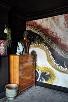 Painted feature wall and vintage wooden chest of drawers 