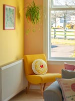 Yellow chair in colourful living room 