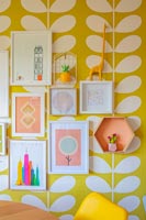 Framed pictures on colourfully wallpapered wall 