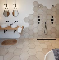 Modern bathroom with hexagonal tiling on floor and wall 