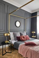 Brass fourposter bed in classic bedroom 