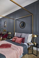 Classic bedroom with brass fourposter bed 