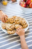 Hands reaching for cookies 