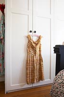 Vintage dress hanging on wardrobe 
