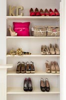 Shoes on shelves in modern bedroom 