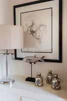Silver ornaments and framed drawing of a horse 