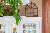 Vintage bird cage on dresser