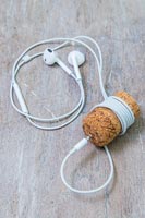 White headphone wire wound around champagne cork