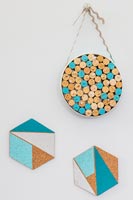 Mini pinboard made from corks placed tightly in a cake tin and hexogan cork with geometric  shapes
