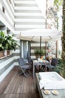 Modern furniture with parasol on balcony