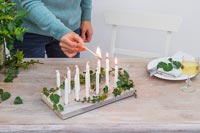 Woman lighting advent candles