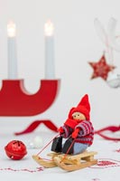 Nordic Christmas figurine on sledge on table decorated table