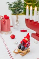 Nordic Christmas figurine on sledge on table decorated table