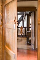 Wooden door opening into hallway 