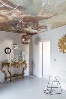 Ornate console table with lavish painted ceiling 