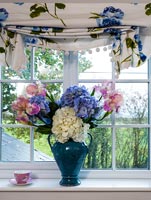 Vase of flowers in window 