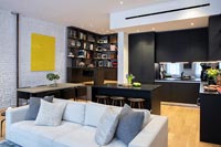 Modern open plan living space with kitchen-diner and corner home office space 