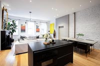 Black kitchen island in modern open plan apartment 