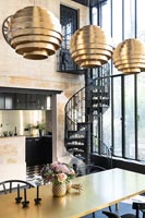 Gold and black modern dining room with view into kitchen
