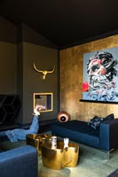 Eclectic black and gold bedroom with feature wall and fireplace 