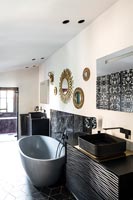 Contemporary monochrome bathroom with mirror display on wall 